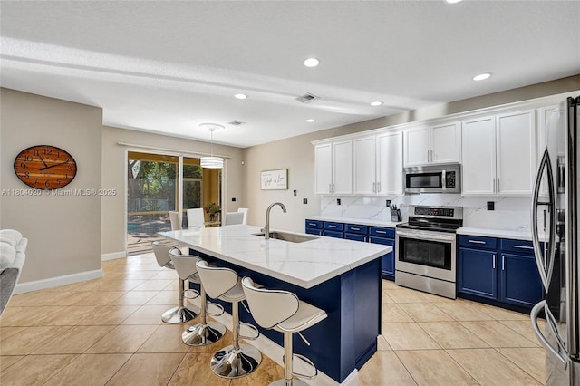 4470 E Seneca Ave, Weston, FL 33332 - kitchen featuring blue cabinetry, stainless steel appliances, white cabinetry, light tile patterned flooring, and recessed lighting