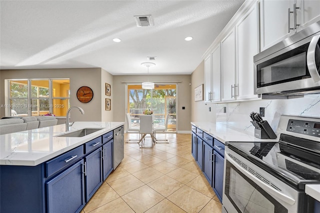 4470 E Seneca Ave, Weston, FL 33332 - kitchen featuring appliances with stainless steel finishes, blue cabinetry, white cabinets, plenty of natural light, and recessed lighting