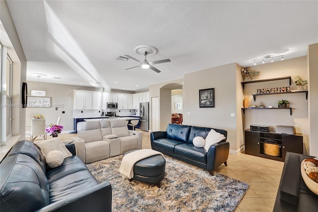 4470 E Seneca Ave, Weston, FL 33332 - living area with arched walkways, a ceiling fan, light tile patterned floors, and a textured ceiling
