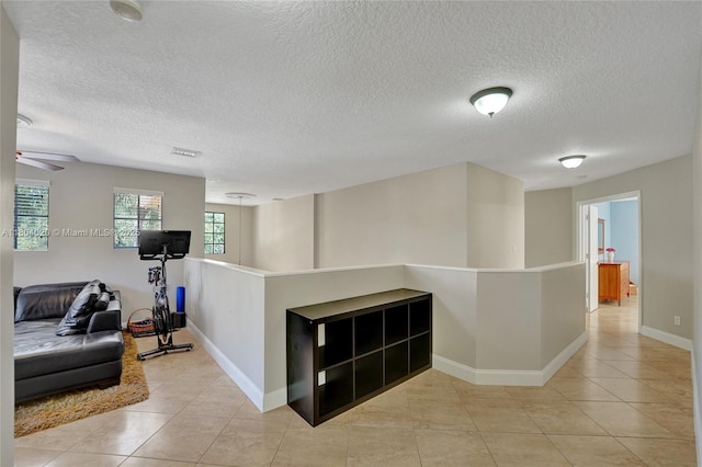 4470 E Seneca Ave, Weston, FL 33332 - hall with light tile patterned flooring and a textured ceiling