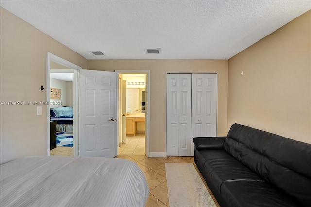 4470 E Seneca Ave, Weston, FL 33332 - bedroom with light tile patterned floors, a closet, and ensuite bath