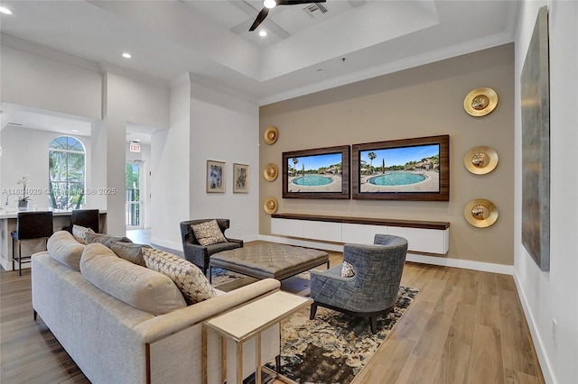 4470 E Seneca Ave, Weston, FL 33332 - living room featuring wood finished floors, ceiling fan, crown molding, a tray ceiling, and recessed lighting