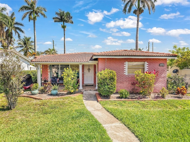 232 SE 6th St, Dania Beach, FL 33004 - ranch-style home with a tiled roof and brick siding
