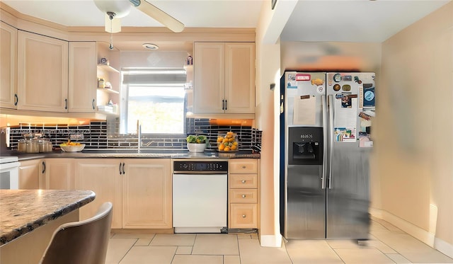 232 SE 6th St, Dania Beach, FL 33004 - kitchen featuring stainless steel fridge, light tile patterned floors, a sink, backsplash, and a ceiling fan