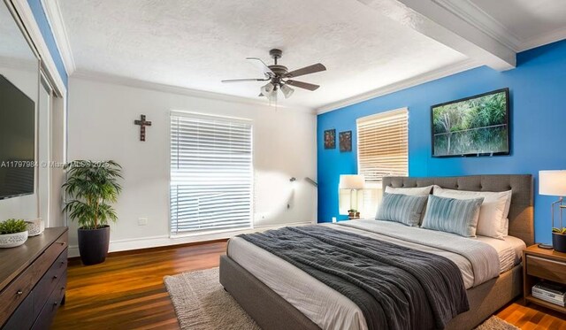 232 SE 6th St, Dania Beach, FL 33004 - bedroom with ornamental molding, wood finished floors, baseboards, ceiling fan, and beam ceiling