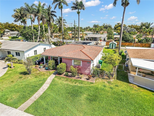 232 SE 6th St, Dania Beach, FL 33004 - view of front facade featuring a tiled roof, brick siding, and central AC unit