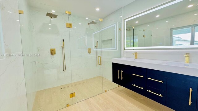 13000 SW 69th Ct, Pinecrest, FL 33156 - bathroom with a marble finish shower, double vanity, recessed lighting, and wood finished floors