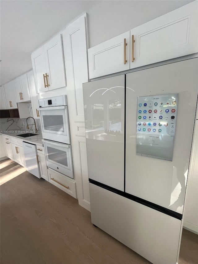 13000 SW 69th Ct, Pinecrest, FL 33156 - kitchen featuring a sink, wood finished floors, white cabinets, white appliances, and light countertops