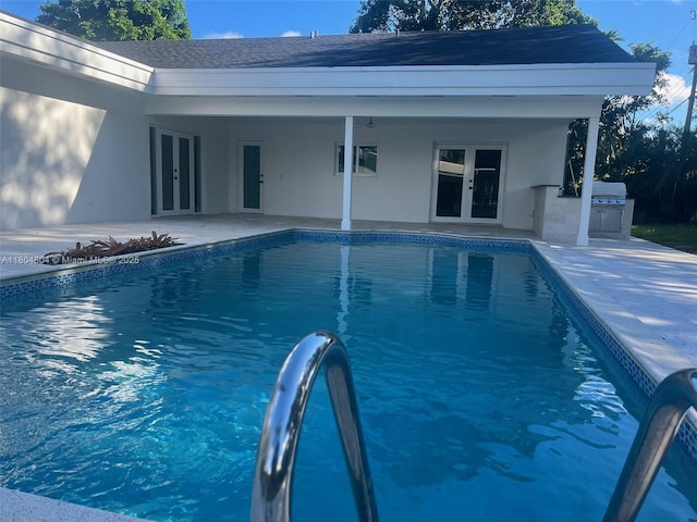 13000 SW 69th Ct, Pinecrest, FL 33156 - swimming pool with french doors, area for grilling, and a patio