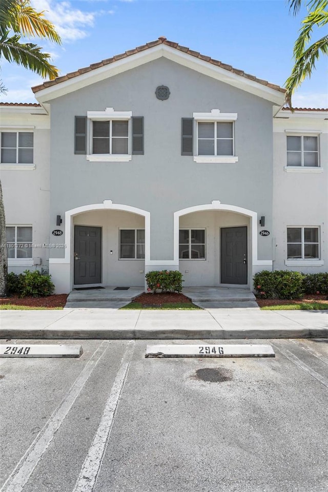 2946 SE 15th Ter, Homestead, FL 33035 - view of property featuring uncovered parking, stucco siding, and a tile roof