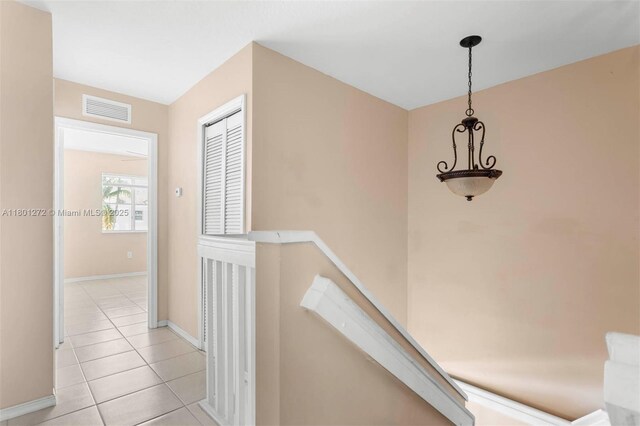 2946 SE 15th Ter, Homestead, FL 33035 - hallway featuring light tile patterned floors, baseboards, and an upstairs landing