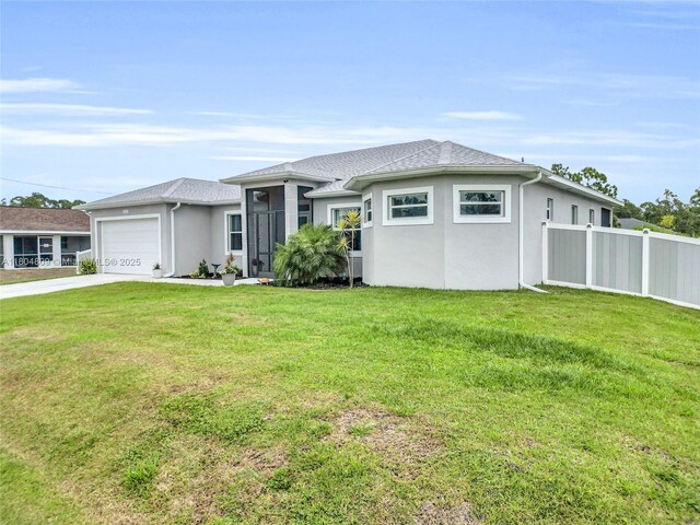 1020 Rush Ave, Lehigh Acres, FL 33972 - prairie-style house featuring a garage, stucco siding, and concrete driveway