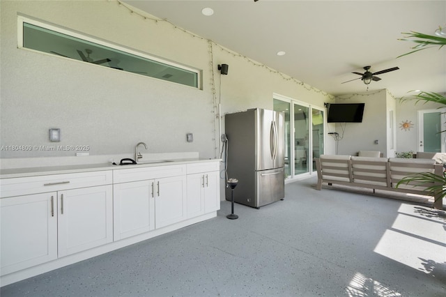1020 Rush Ave, Lehigh Acres, FL 33972 - kitchen with freestanding refrigerator, a sink, white cabinets, ceiling fan, and light countertops