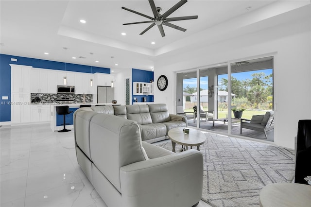 1020 Rush Ave, Lehigh Acres, FL 33972 - living area featuring recessed lighting, a ceiling fan, light marble finish flooring, and a raised ceiling