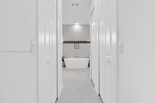 1020 Rush Ave, Lehigh Acres, FL 33972 - hallway with light marble finish floors