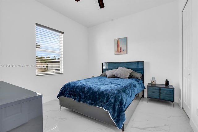 1020 Rush Ave, Lehigh Acres, FL 33972 - bedroom with marble look tile flooring, baseboards, and a ceiling fan