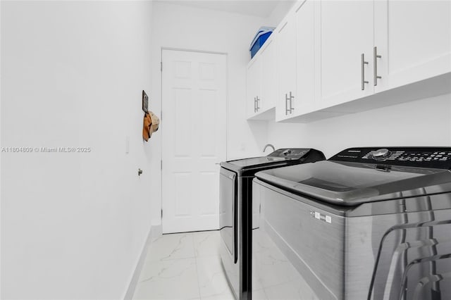 1020 Rush Ave, Lehigh Acres, FL 33972 - laundry area with washer and clothes dryer, light marble finish floors, cabinet space, and baseboards