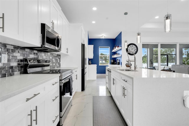 1020 Rush Ave, Lehigh Acres, FL 33972 - kitchen featuring stainless steel appliances, a sink, light marble finish floors, recessed lighting, and backsplash
