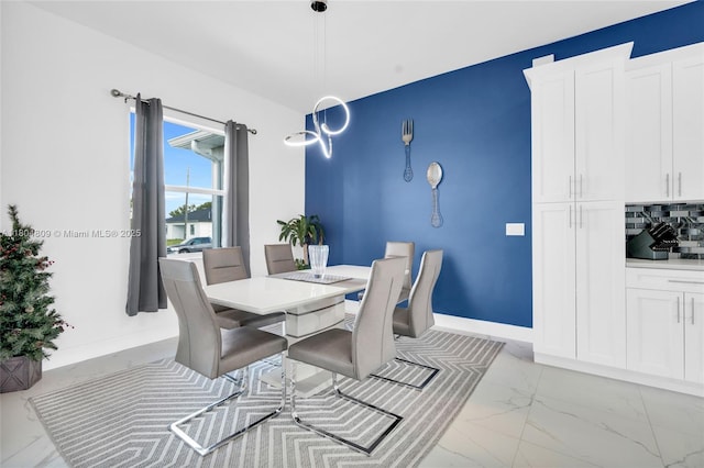 1020 Rush Ave, Lehigh Acres, FL 33972 - dining room featuring light marble finish floors and baseboards