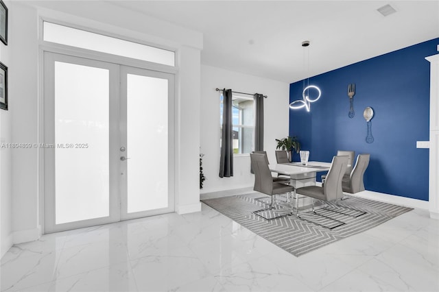 1020 Rush Ave, Lehigh Acres, FL 33972 - dining area with marble finish flooring, french doors, and baseboards