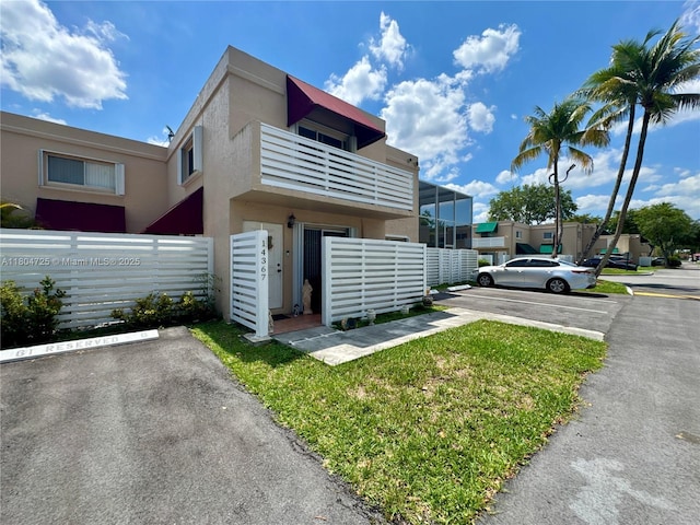 14367 SW 96th Ln, Miami, FL 33186 - view of building exterior with uncovered parking and fence