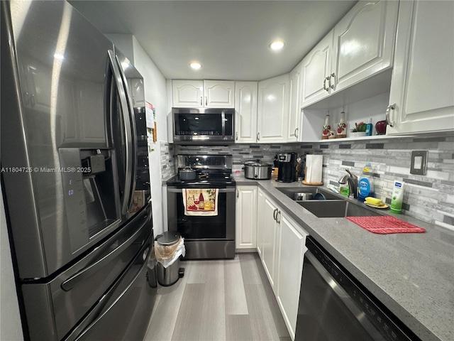14367 SW 96th Ln, Miami, FL 33186 - kitchen featuring appliances with stainless steel finishes, white cabinetry, tasteful backsplash, wood finished floors, and open shelves