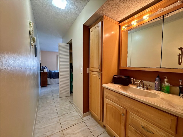 14367 SW 96th Ln, Miami, FL 33186 - bathroom featuring marble look tile flooring, vanity, and a textured ceiling
