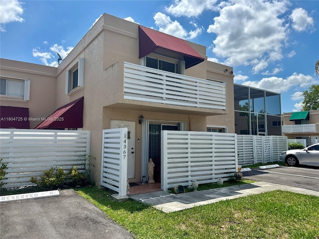 14367 SW 96th Ln, Miami, FL 33186 - view of front facade featuring uncovered parking, stucco siding, and fence