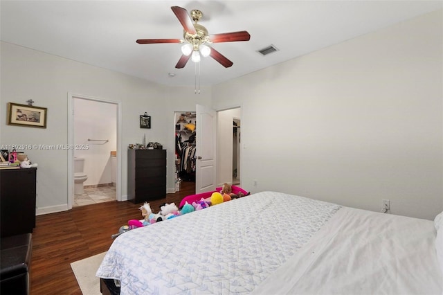 922 SW 148th Pl, Miami, FL 33194 - bedroom featuring wood finished floors, a spacious closet, ensuite bathroom, a closet, and a ceiling fan