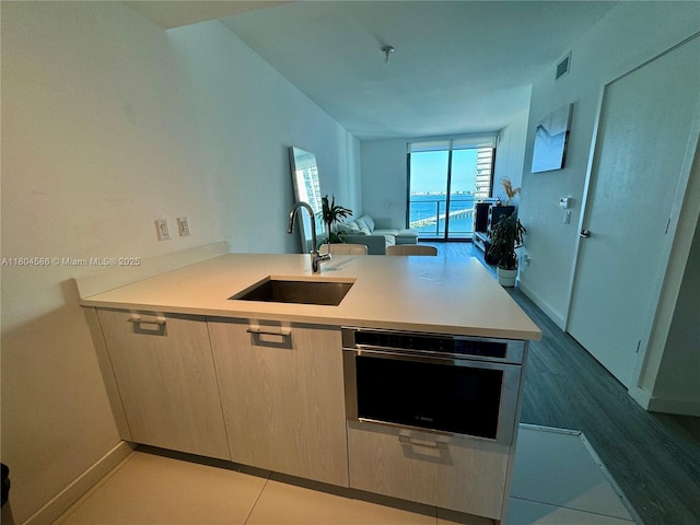 501 NE 31st St Unit 2903, Miami, FL 33137 - kitchen featuring a sink, open floor plan, light countertops, and baseboards