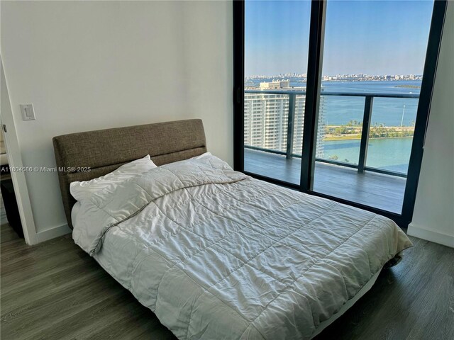 501 NE 31st St Unit 2903, Miami, FL 33137 - bedroom featuring baseboards, wood finished floors, access to outside, a water view, and a city view
