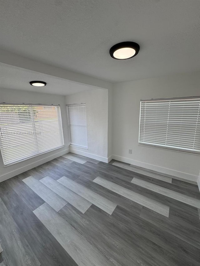 1794 NW 74th Ter, Miami, FL 33147 - spare room with baseboards, dark wood-style floors, and a textured ceiling