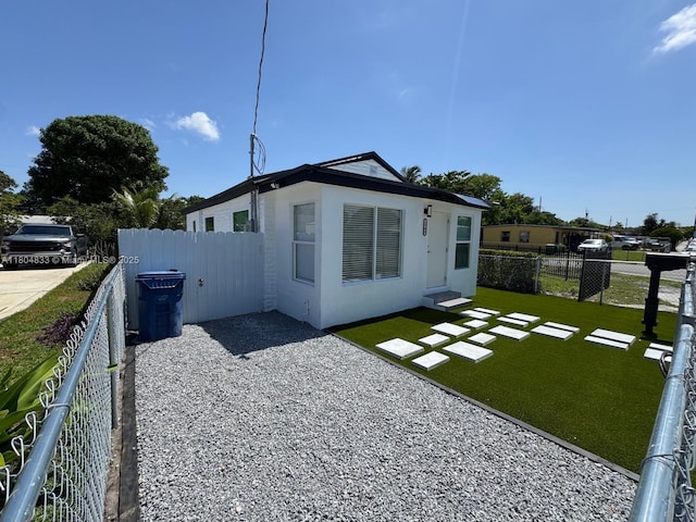 1794 NW 74th Ter, Miami, FL 33147 - back of property featuring entry steps, stucco siding, and a patio area