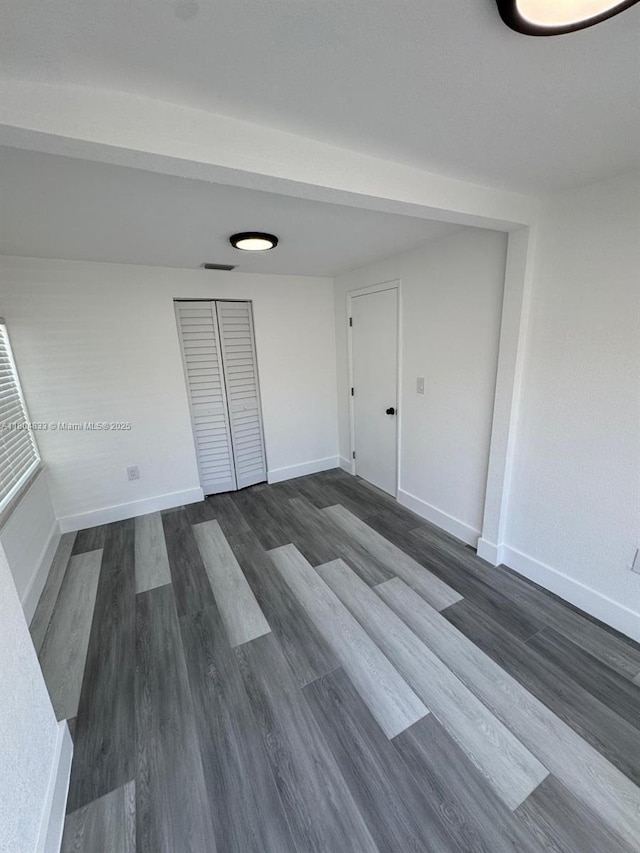 1794 NW 74th Ter, Miami, FL 33147 - spare room with dark wood-style floors and baseboards