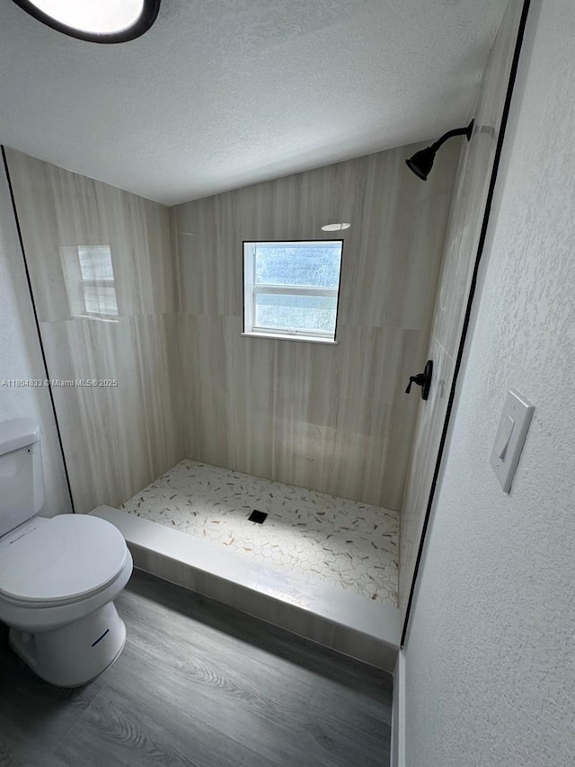 1794 NW 74th Ter, Miami, FL 33147 - bathroom with a shower stall, toilet, wood finished floors, and a textured ceiling