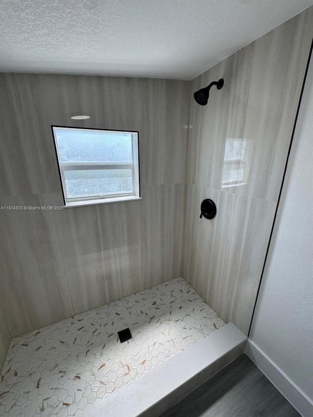 1794 NW 74th Ter, Miami, FL 33147 - full bathroom with a tile shower, a textured ceiling, and wood finished floors