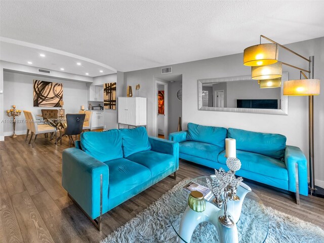 3800 Hillcrest Dr Unit 907, Hollywood, FL 33021 - living room featuring a textured ceiling, wood finished floors, recessed lighting, and baseboards