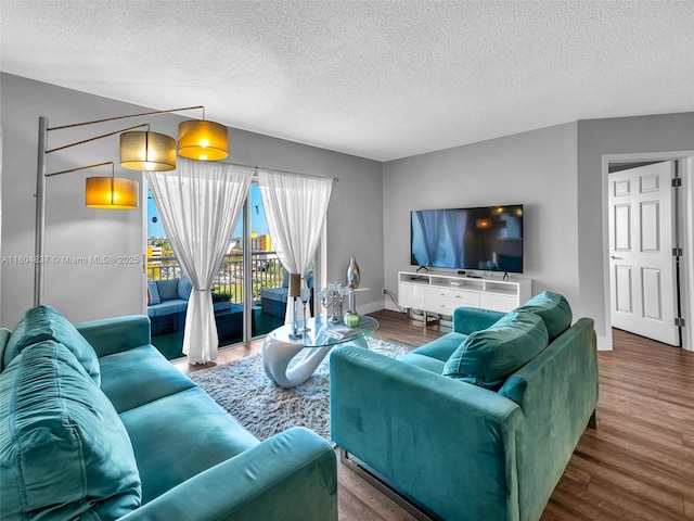 3800 Hillcrest Dr Unit 907, Hollywood, FL 33021 - living area featuring a textured ceiling, wood finished floors, and baseboards