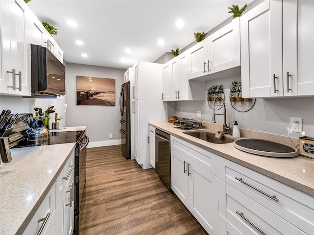 3800 Hillcrest Dr Unit 907, Hollywood, FL 33021 - kitchen featuring black appliances, dark wood-type flooring, white cabinets, baseboards, and recessed lighting