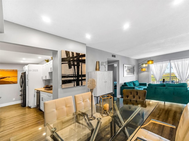 3800 Hillcrest Dr Unit 907, Hollywood, FL 33021 - dining space featuring light wood-type flooring, recessed lighting, and baseboards