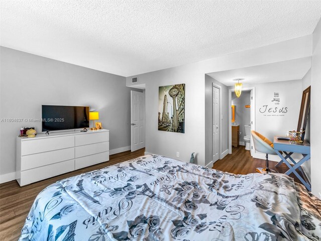 3800 Hillcrest Dr Unit 907, Hollywood, FL 33021 - bedroom with wood finished floors, a textured ceiling, and baseboards