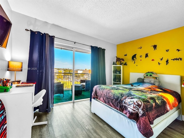 3800 Hillcrest Dr Unit 907, Hollywood, FL 33021 - bedroom with wood finished floors, access to exterior, and a textured ceiling