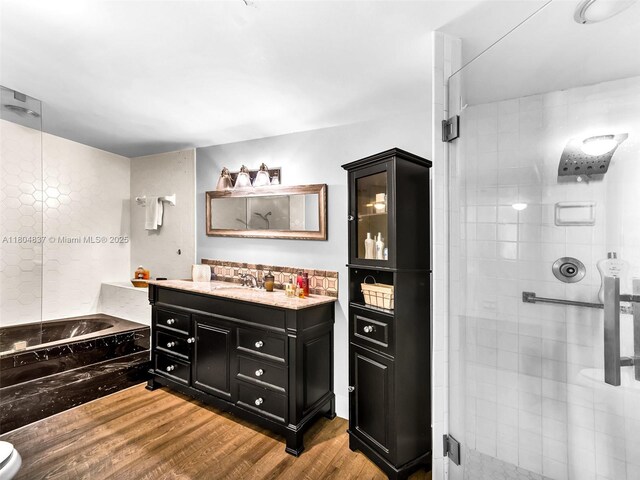 3800 Hillcrest Dr Unit 907, Hollywood, FL 33021 - bathroom with a shower stall, wood finished floors, vanity, and a bath