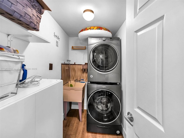 3800 Hillcrest Dr Unit 907, Hollywood, FL 33021 - washroom with stacked washer and clothes dryer and wood finished floors