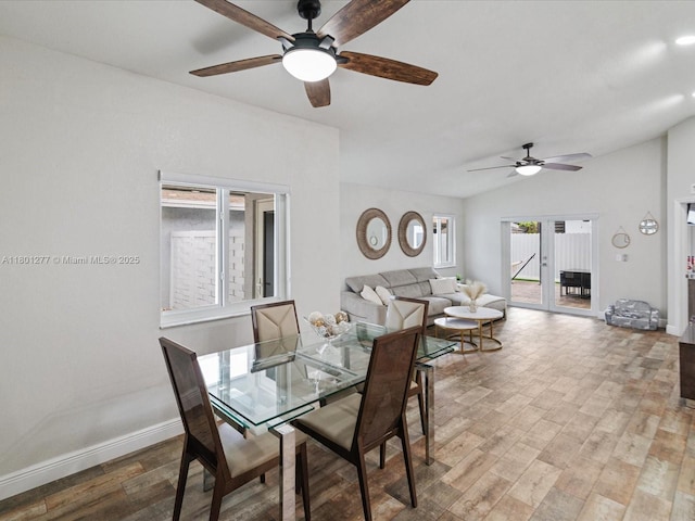 dining room featuring ceiling fan, baseboards, wood finished floors, and lofted ceiling