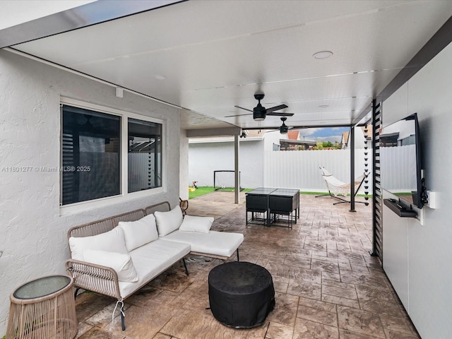 view of patio featuring outdoor dining area, fence, outdoor lounge area, and ceiling fan