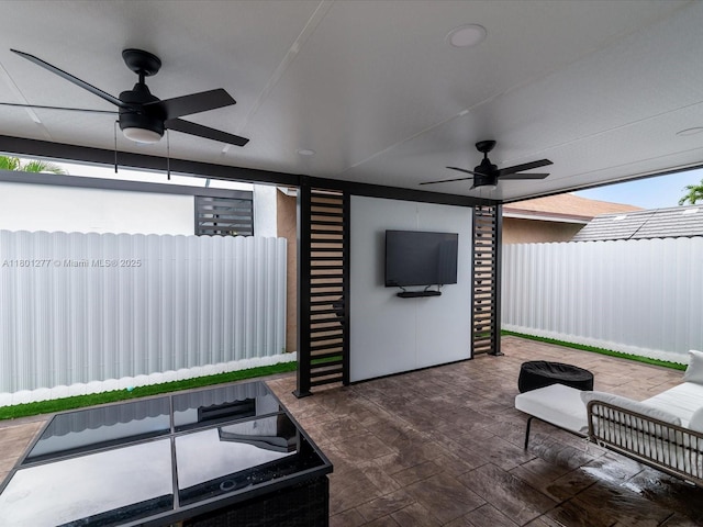 view of patio / terrace featuring a ceiling fan and fence