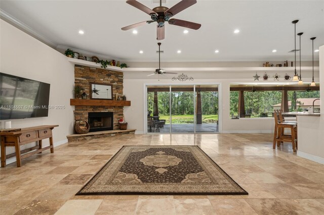 3324 Miller Ave, Lake Placid, FL 33852 - unfurnished living room featuring ceiling fan, ornamental molding, a stone fireplace, baseboards, and recessed lighting