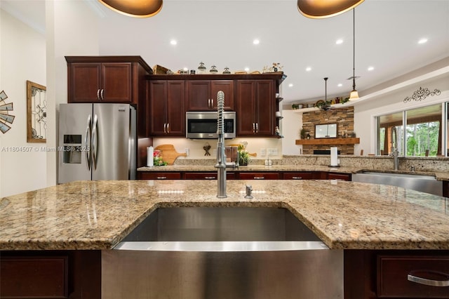 3324 Miller Ave, Lake Placid, FL 33852 - kitchen featuring appliances with stainless steel finishes, a sink, light stone counters, recessed lighting, and ornamental molding