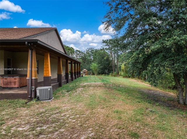 3324 Miller Ave, Lake Placid, FL 33852 - view of grassy yard with central AC unit and a hot tub